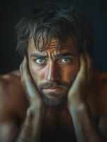 Thoughtful Man with Intense Blue Eyes Staring photo