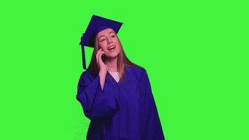 Graduated student using smartphone and talking on the phone on green screen video