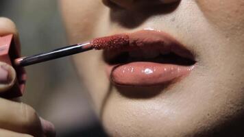 A close-up image showcasing the application of lipstick, highlighting its gloss and texture. Perfect for beauty or cosmetic projects. video