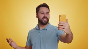 Happy young man traveler blogger taking selfie on smartphone communicating call online stream video