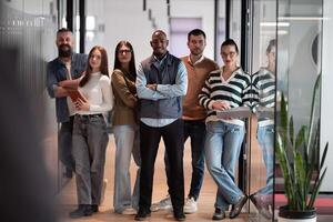 A diverse, multiethnic business team of entrepreneurs and leaders in a modern office, collaborating in an open space. Their teamwork, motivation, and partnership fuel the company's growth and success photo