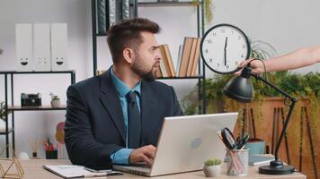 Young businessman with anxiety checking time on clock, running late to work being in delay deadline video