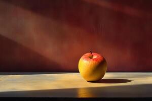 A Single Red and Yellow Apple on a Wooden Surface with Sunbeams photo
