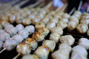 Top view Pork meatballs grill on a charcoal stove, focus selective photo