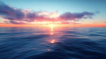 A sunset over the ocean with clouds and water photo