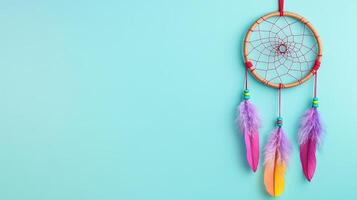 Colorful Dreamcatcher with Feathers Against a Turquoise Background photo