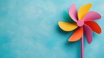 Colorful Pinwheel on Soft Blue Background for Whimsical Vibes photo