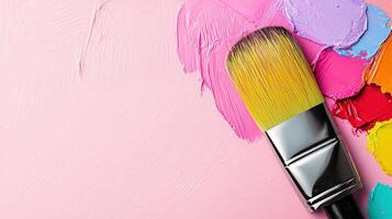 Vibrant Brush and Colorful Paints on Pink Canvas Background photo
