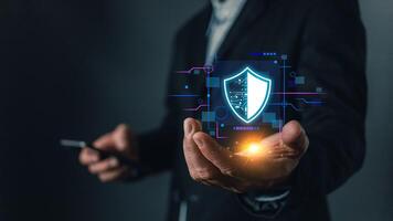 Cybersecurity and privacy protection network security computer and safe data concept. Businessmen protect personal data information from viruses on a laptop with virtual screen interfaces photo