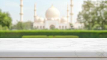 White marble tabletop with blurred background of a large mosque, suggesting space for product placement photo