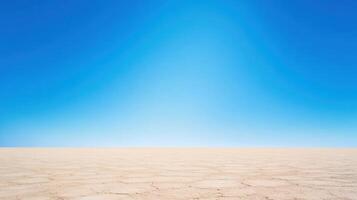 Expansive desert landscape with a vast, clear blue sky above, showcasing stark beauty and serenity photo