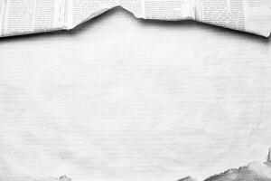 Torn edges reveal a faded newspaper background, offering a vintage texture for creative projects photo