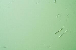 Textured light green wall with streaks of white, creating depth and subtle visual interest photo