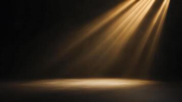 Dramatic golden light beams illuminating a stage floor creating a stark contrast in the dark photo