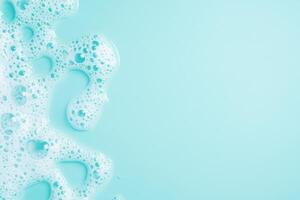 Foam and bubbles in a turquoise bath water setting. Soothing and relaxing background. Space for text photo