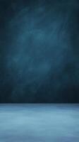 Studio shot of a textured blue wall and floor providing a simple, muted, and elegant backdrop photo