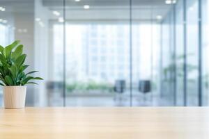 Plant on a desk in a bright office space with glass walls and a blurred background view photo
