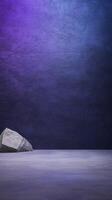 A large stone sits on a flat purple surface against a textured, gradient blue to purple backdrop photo