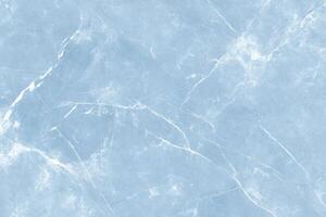 Powder blue surface with delicate white veining resembling natural stone or marble pattern photo