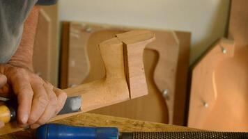 Luthier working with a chisel video