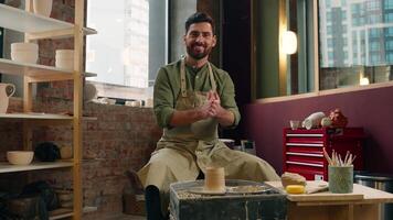 Confident talented happy Caucasian man guy businessman male small business owner potter crock in apron rubbing hands clapping looking camera ready to work creating pottery clay ceramic inside workshop video