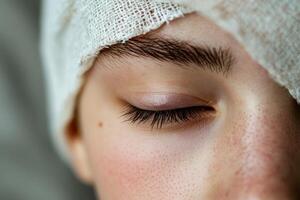 A close up of a woman's eye with a bandage photo