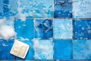White soap produces delicate bubbles atop a stunning blue and white mosaic wall, revealing intricate tile textures in a serene moment photo