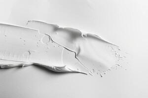 Soft, flowing white paint glides over a smooth watercolor paper surface, inviting creativity and contemplation in a serene moment photo