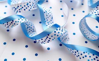 Blue ribbon twists gracefully across a pristine white background filled with playful blue dots and lines, creating an appealing decorative display photo