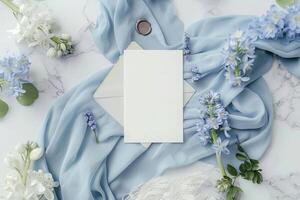 A beautifully arranged display of wedding invitation cards nestled among delicate flowers and soft fabric highlights a romantic theme perfect for weddings photo