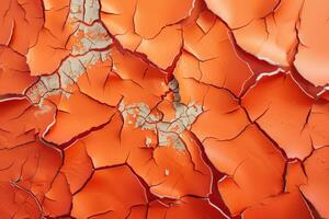 This close-up view reveals an orange wall where layers of paint have started to peel, showcasing intricate textures and cracked surfaces photo