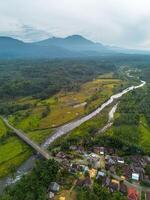 An aerial view of a village and river photo