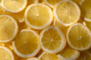Bright yellow lemon slices create a fresh, vibrant display in a sunlit kitchen setting during summer photo