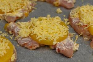 Juicy chicken topped with pineapple and cheese ready for baking in a cozy kitchen photo