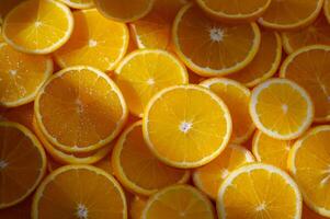 Freshly sliced oranges create a vibrant and sunny display of citrus delight in a rustic kitchen photo