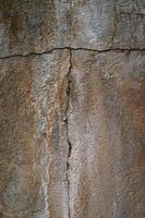 Cracked wall texture reveals layers of history in warm earthy tones photo