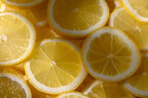 Sliced lemons arranged in vibrant patterns create a refreshing burst of color for summer recipes photo