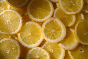 Bright yellow lemon slices arranged in a vibrant pattern create a refreshing and zesty visual delight photo