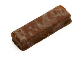 Delightful chocolate bar resting on a clean surface showcasing its smooth texture and rich color photo