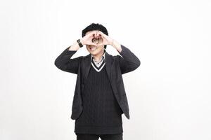 A man in a suit and tie is making a heart shape photo