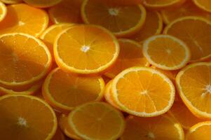 Fresh slices of vibrant oranges basking in sunlight in a lively kitchen setting photo