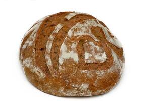 Freshly baked round sourdough loaf with a rustic appearance and delicate scoring patterns photo