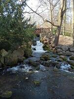 Scenic natural waterfall flowing over rocks photo