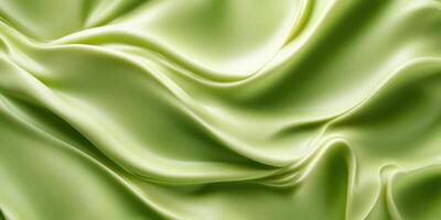 Luxurious flowing pistachio green satin fabric photo
