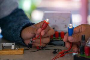 students are conducting experiments on basic electrical circuits. Concept of science classroom, learning, science skills, learning, science experiments. photo