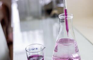 A beaker with a liquid in it and a glass photo