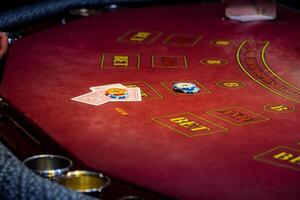 A casino table with a red and black poker table photo