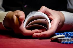 A man holding a stack of cards and chips photo
