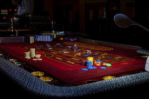 A table with a craps game and a light photo