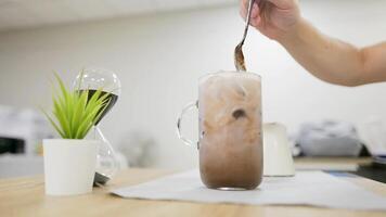 Ice chocolate on a wood table with milk on table video